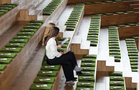 Fold ud stol i grøn filt i auditorium