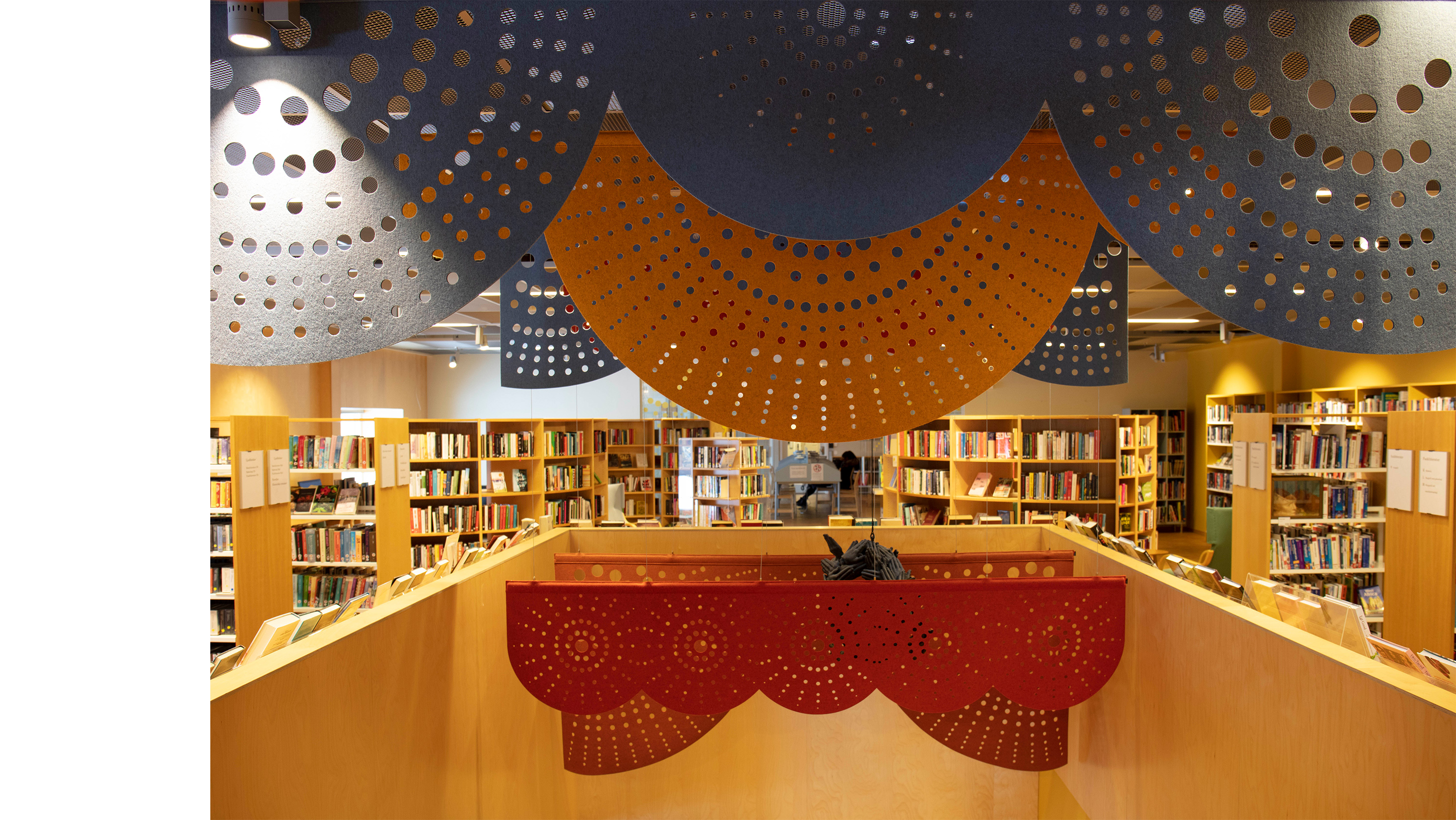 rødt og gult filt med udskæringer nedhængt fra loft