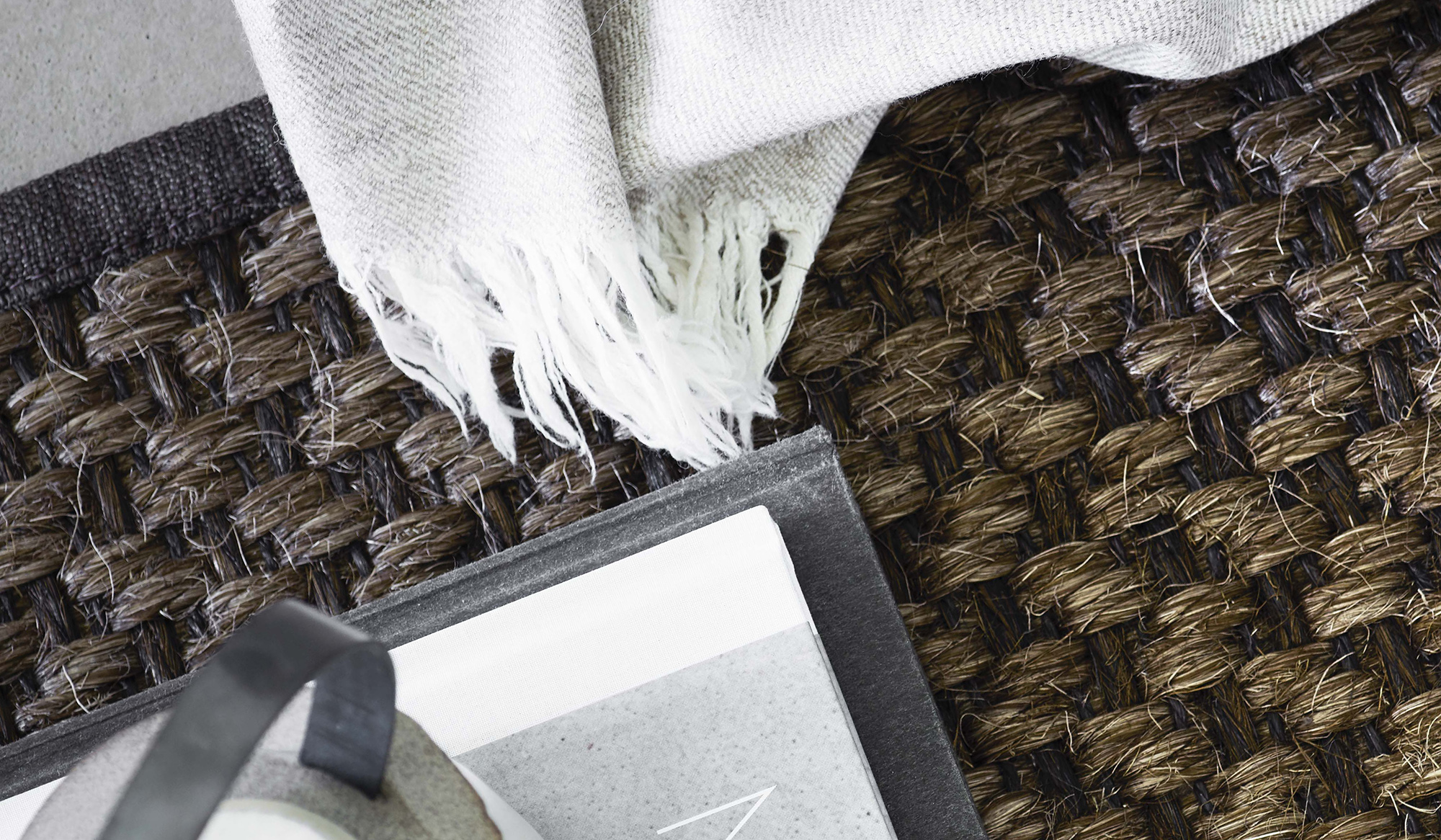 Togo area rug in brown sisal with white blanket